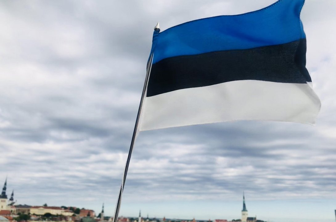 Estonian flag on the backdrop of Old Town Tallinn