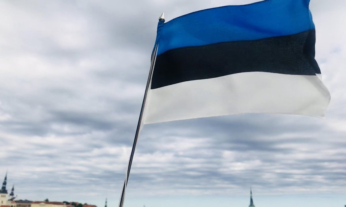 Estonian flag on the backdrop of Old Town Tallinn